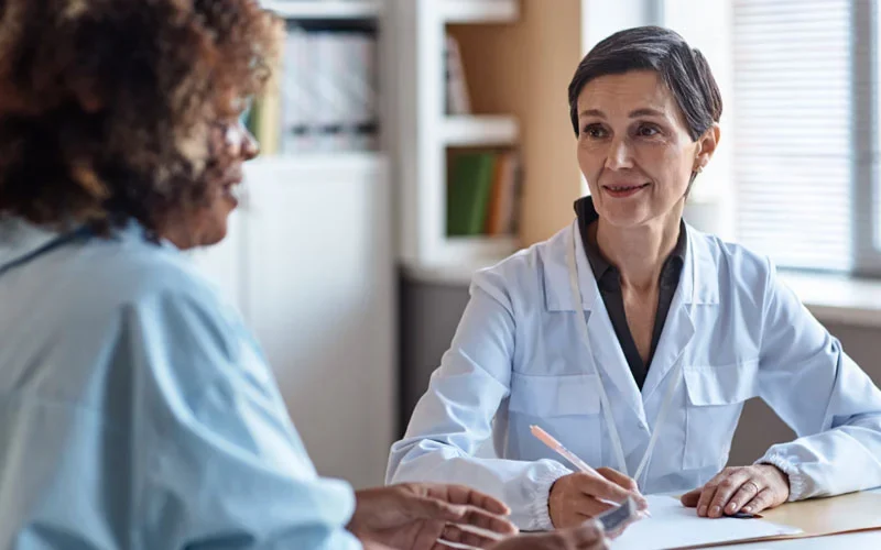 Professional receptionist conducting outbound patient reminder calls for a healthcare clinic